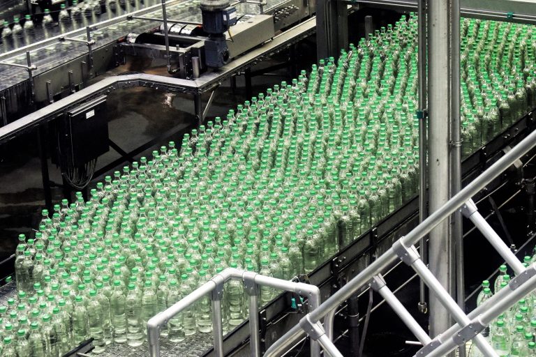 glass bottles on top of gray machine